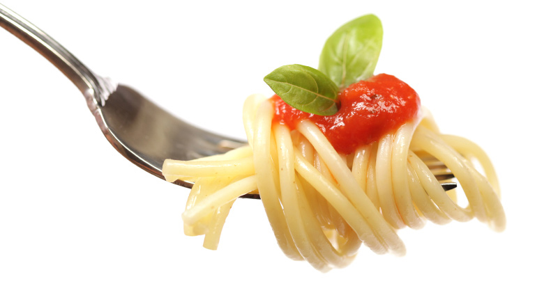 Pasta on fork with sauce and basil